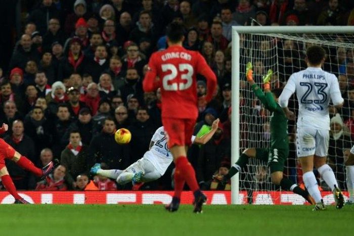 Liverpool's Welsh striker Ben Woodburn (L) scores his team's second goal during the English League Cup quarter-final football match between Liverpool and Leeds United at Anfield in Liverpool, north west England on November 29, 2016