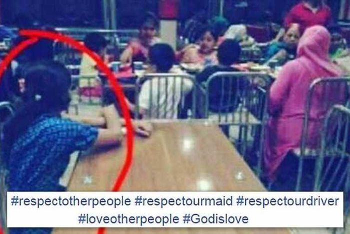 Maid is seen looking on at employer and family