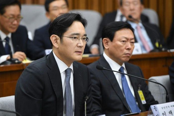 Samsung Group's heir-apparent Lee Jae-Yong (L) answers a question as Lotte Group Chairman Shin Dong-Bin listens during a parliamentary probe into a scandal engulfing President Park Geun-Hye, at the National Assembly in Seoul, on December 6, 2016