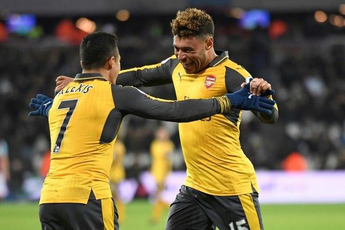 Arsenal's Alexis Sanchez (L) celebrates with teammate Alex Oxlade-Chamberlain after scoring a goal during their English Premier League match against West Ham United, at The London Stadium, on December 3, 2016