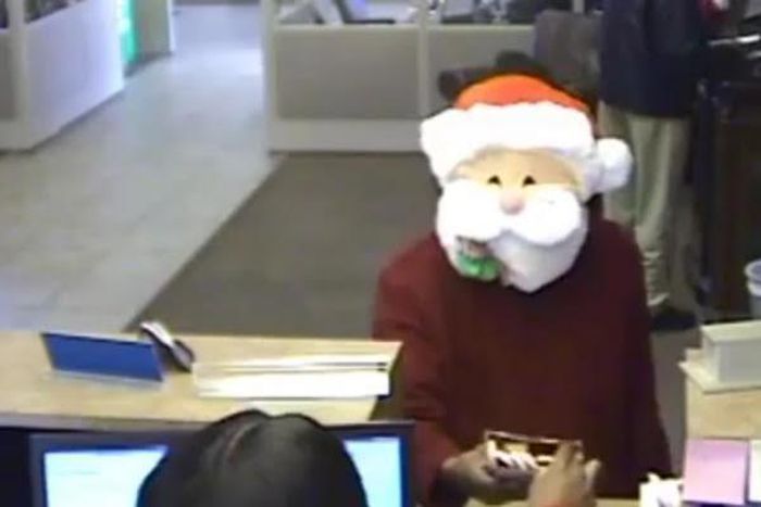 Santa Claus gives out candy before robbing a bank in America.