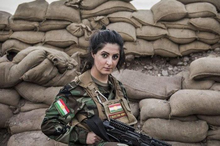 Joanna Palani, holding a weapon.