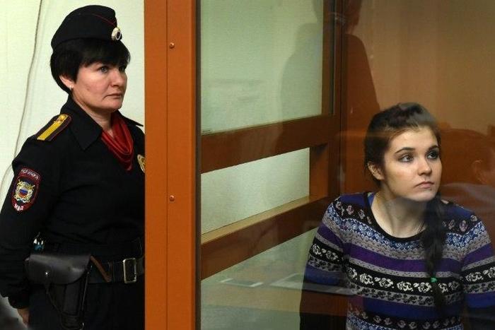 Moscow State University student Varvara Karaulova sits inside a defendants' cage during a hearing at the District Military Court on October 13, 2016