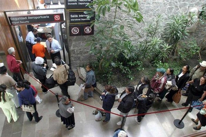Passengers go through security at Toluca airport in Mexico, where authorities have seized $450 million worth of debt securities