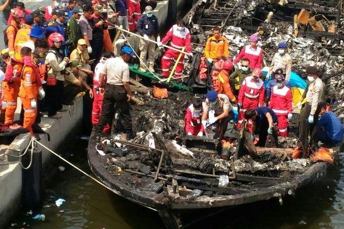 Rescuers search a charred remains of a passenger boat after it caught fire while ferrying around 200 people off the coast of Jakarta to Tidung island, a tourist destination 50 kilometres (30 miles) from the capital on January 1, 2017