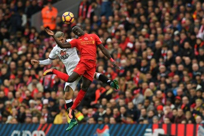 Watford's midfielder Valon Behrami (L) jumps for the ball against Liverpool's midfielder Sadio Mane on November 6, 2016