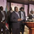 Riek Machar (L), flanked by South Sudan President Salva Kiir (C) and other government officials, addresses a news conference at the Presidential State House in Juba, South Sudan, July 8, 2016.