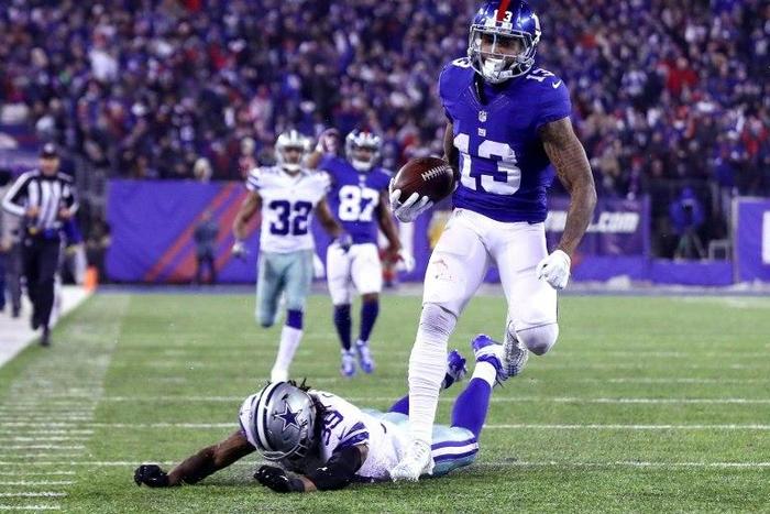 Odell Beckham of the New York Giants runs with the ball to the end zone to score a 61 yard touchdown against the Dallas Cowboys during the third quarter, at MetLife Stadium in East Rutherford, New Jersey, on December 11, 2016