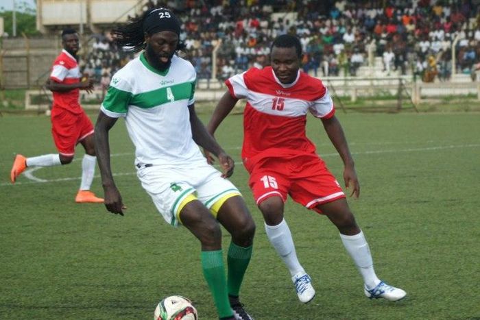 Togo national football team skipper Emmanuel Adebayor (L) tries to controll the ball during an exhibition match to mourn former coach in Lome, on June 19, 2016