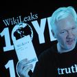 Julian Assange, founder of the online leaking platform WikiLeaks, addresses journalists via a live video connection during a press conference on the platform's 10th anniversary