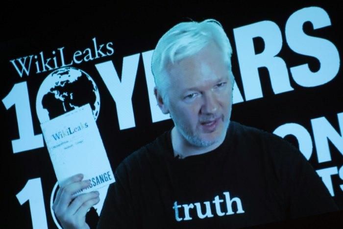 Julian Assange, founder of the online leaking platform WikiLeaks, addresses journalists via a live video connection during a press conference on the platform's 10th anniversary