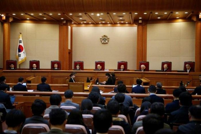 Nine judges of South Korea's Constitutional Court attend the first full hearing on whether to confirm the impeachment of President Park Geun-hye