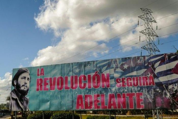 A billboard depicting Cuban revolutionary leader Fidel Castro and reading "The Revolution Will Go On," is seen in Havana, on November 27, 2016 two days after his death