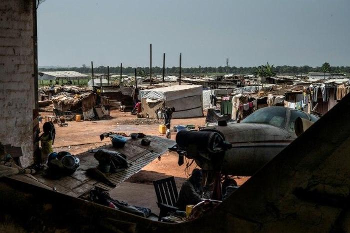 People go about their daily lives at a refugee and displaced persons camp at the M'Poko airport in Bangui on December 7, 2015