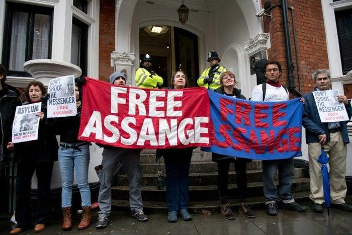Protesters hold banners that read "Free Assange" outside the Ecuadorian Embassy in London on November 14, 2016
