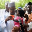 Governor Atiku Bagudu Of Kebbi State, Deworming A Child During Maternal Newborn And Child Health Week In Birnin Kebbi on August 10, 2015.