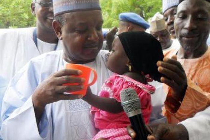 Governor Atiku Bagudu Of Kebbi State, Deworming A Child During Maternal Newborn And Child Health Week In Birnin Kebbi on August 10, 2015.