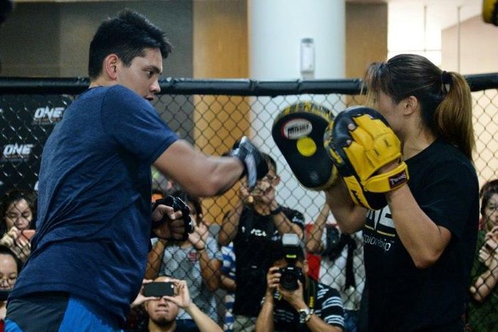 Asian fighter Angela Lee (right) teaches some basic mixed martial arts (MMA) techniques to Olympic swimmer Joseph Schooling during a training session in Singapore, on November 24, 2016