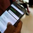 An employee assists a customer to set-up M-Pesa money transfer servive on his handset inside a mobile phone care centre operated by Kenyan's telecom operator Safaricom; in the central business district of Kenya's capital Nairobi, May 11, 2016. REUTERS/...