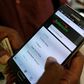 An employee assists a customer to set-up M-Pesa money transfer servive on his handset inside a mobile phone care centre operated by Kenyan's telecom operator Safaricom; in the central business district of Kenya's capital Nairobi, May 11, 2016. REUTERS/...