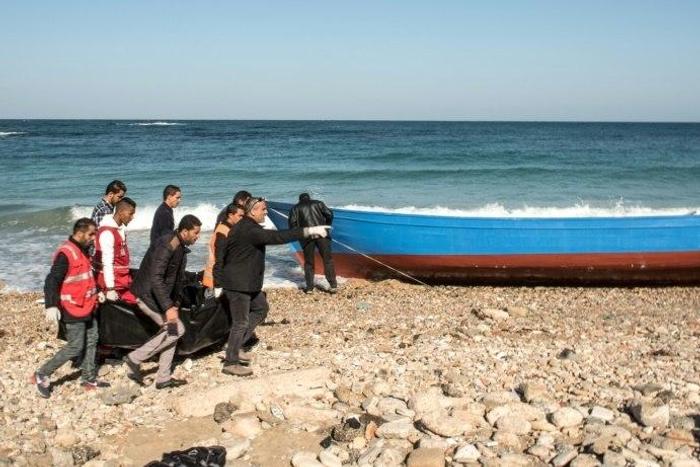 Members of the Libyan Red Crescent carry the bodies of drowned immigrants after they washed ashore in the Andalus district of the capital Tripoli, on January 4, 2017