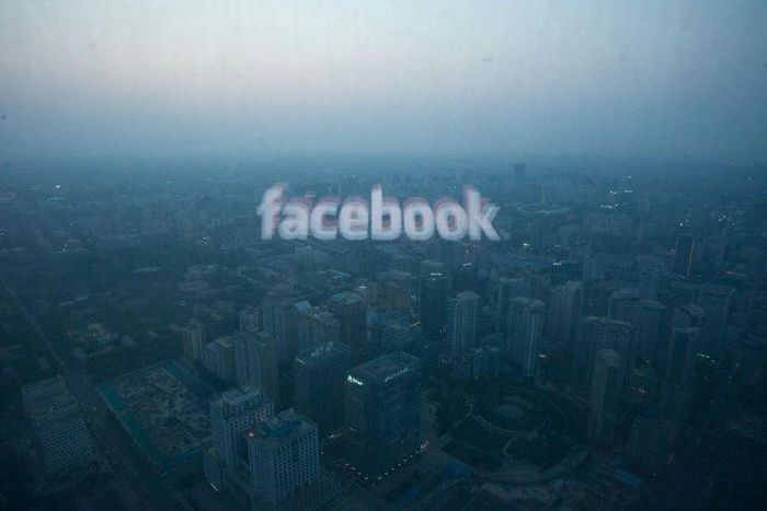 A computer screen displays the logo of social networking site Facebook against the backdrop of the Beijing skyline