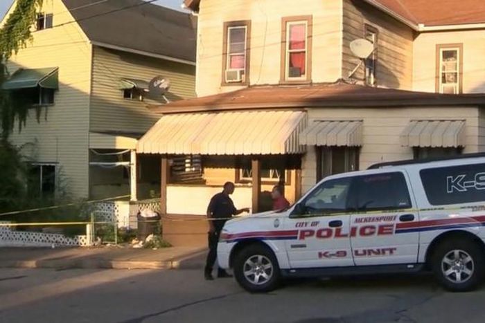A police vehicle parked in from the deceased residence