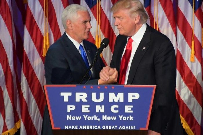 Republican presidential-elect Donald Trump (right) shakes hands with vice president-elect Mike Pence during a post election party in New York, on November 9, 2016