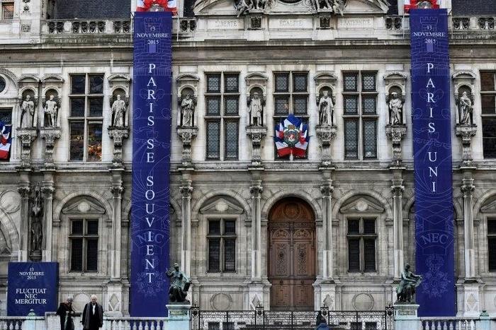 Banners reading "Paris remembers" and "Paris United" in memory of the victims of last year's November 13 jihadist attacks in and around Paris on the facade of Paris' City Hall