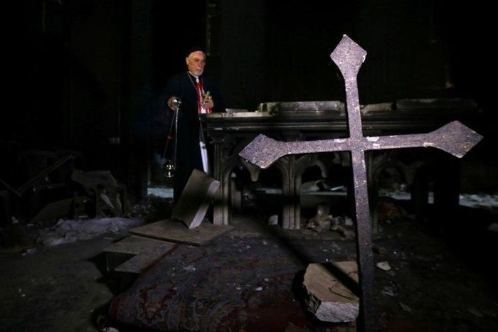 Archbishop Yohanna Petros Mouche of Mosul prays at the St. George Syriac Catholic Church in the Christian Iraqi town of Bartella, east of Mosul on October 30, 2016