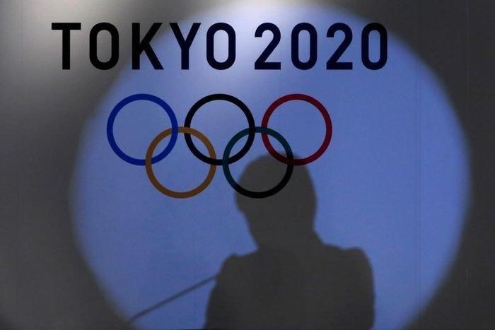 A shadow of of Tokyo governor Yuriko Koike is seen on the logo of Tokyo 2020 Olympic games during the Olympic and Paralympic flag-raising ceremony at Tokyo Metropolitan Government Building in Tokyo, Japan, September 21, 2016.