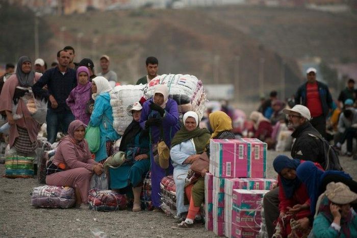 People await on the beach before crossing the El Tarajal border, separating Morocco and Spain's North African enclave of Ceuta, in Ceuta