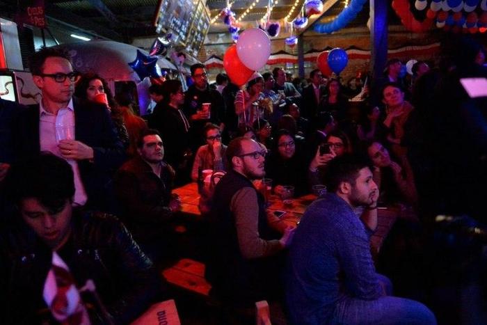 People gather at a bar in Mexico City, as US poll results come in, on November 8, 2016