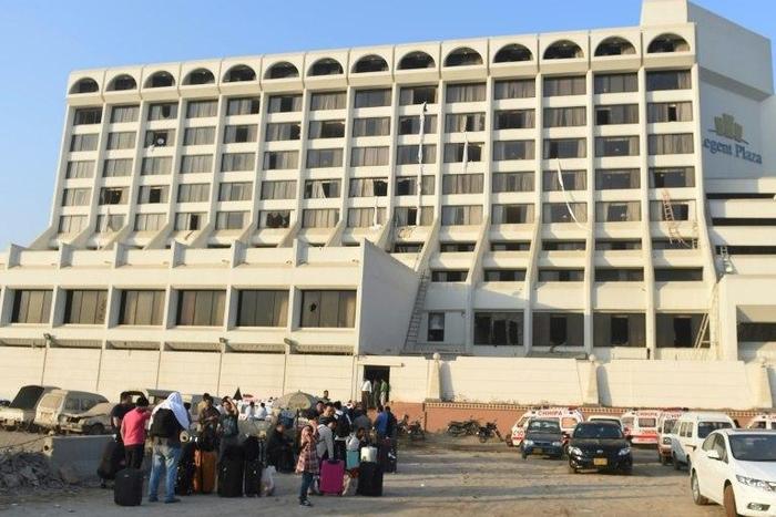 Guests gather outside Regent Plaza Hotel in Karachi, following a pre-dawn fire, on December 5, 2016