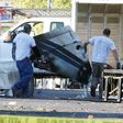 Wreckage is removed from the scene of a twin-engine plane that struck a utility pole and burst into flames in downtown East Hartford, Connecticut U.S., October 12, 2016.