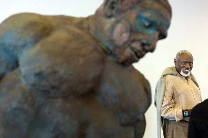 Senegalese artist Ousmane Sow is pictured in 2013 near near one of his sculptures in Besancon, eastern France