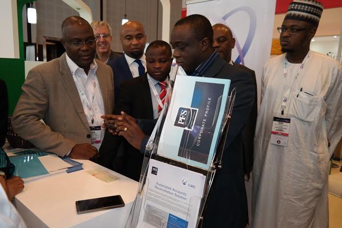MD/CEO, Precise Financial Systems [PFS], [middle] demonstrates how the iTeller Mobile Cheque Truncations works while Deputy MD, PFS, Philips Ayeni (left), President, Nigeria Computer Society [NCS] Prof. Sola Aderonmu, [second left) and Director General...