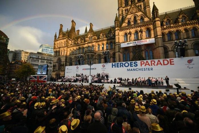 A rainbow appears in the sky as members of the British Olympic and Paralympic teams take part in their "Heroes Parade"