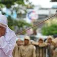 A Muslim woman is caned in Banda Aceh, Indonesia, on October 17, 2016