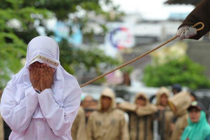 A Muslim woman is caned in Banda Aceh, Indonesia, on October 17, 2016