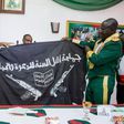 Army presents captured Boko Haram flag to President Muhammadu Buhari