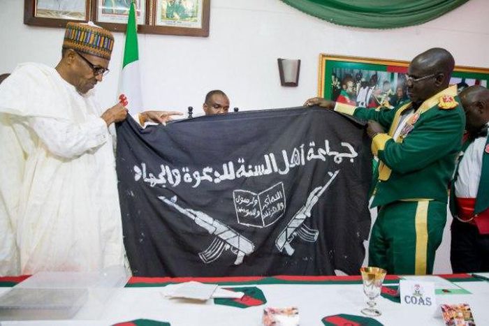 Army presents captured Boko Haram flag to President Muhammadu Buhari