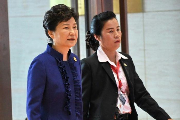 South Korean President Park Geun-Hye (L) is scrambling to deflect public anger over allegations her close friend Choi Soon-sil has meddled in state affairs