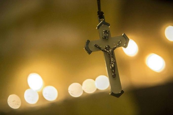 Egyptians attend a candlelight vigil outside the Saint Peter and Saint Paul Coptic church in Cairo on December 17, 2016
