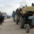 A tractor carrying people evacuated from rebel-held neighbourhoods of Aleppo arrives in opposition-controlled Khan al-Assal on December 16, 2016