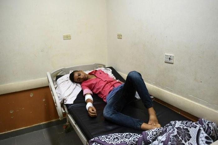 Rescued migrant Sameh Mohamed Ahmed Abdel Dayem, an 18-year-old Egyptian student from Kafr El-Sheikh, lies in a bed at Rashid hospital in Rosetta, northern Egypt, on September 21, 2016