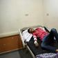 Rescued migrant Sameh Mohamed Ahmed Abdel Dayem, an 18-year-old Egyptian student from Kafr El-Sheikh, lies in a bed at Rashid hospital in Rosetta, northern Egypt, on September 21, 2016