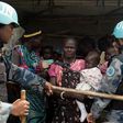 United Nations peacekeepers control South Sudanese women and children before the distribution of emergency food supplies at the United Nations protection of civilians (POC) site 3 hosting about 30,000 people displaced during the recent fighting in Juba...