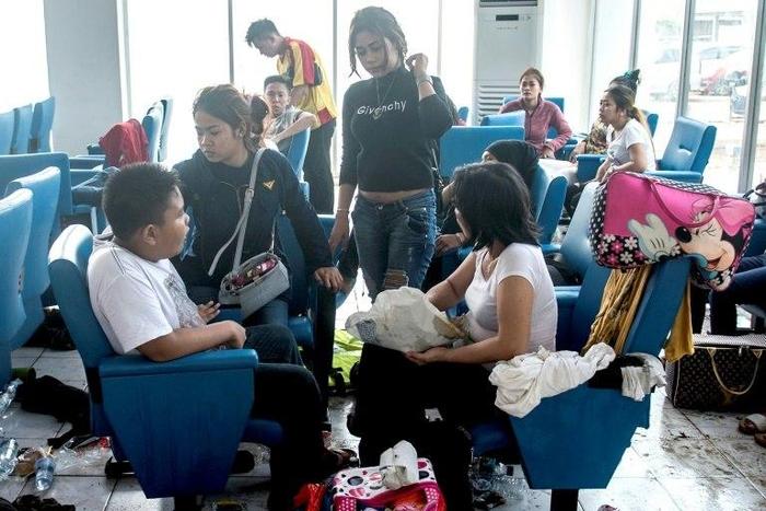 Survivors of the Zahro Express fire -- the boat's captain has been held by Indonesian police for suspected negligence