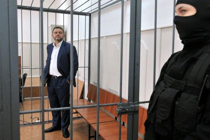 Nikita Belykh, accused by Russia's Investigative Committee of accepting a bribe of 400,000 euros ($430,800), stands inside a defendants' cage during a hearing at the Basmanny district court in Moscow on June 25, 2016